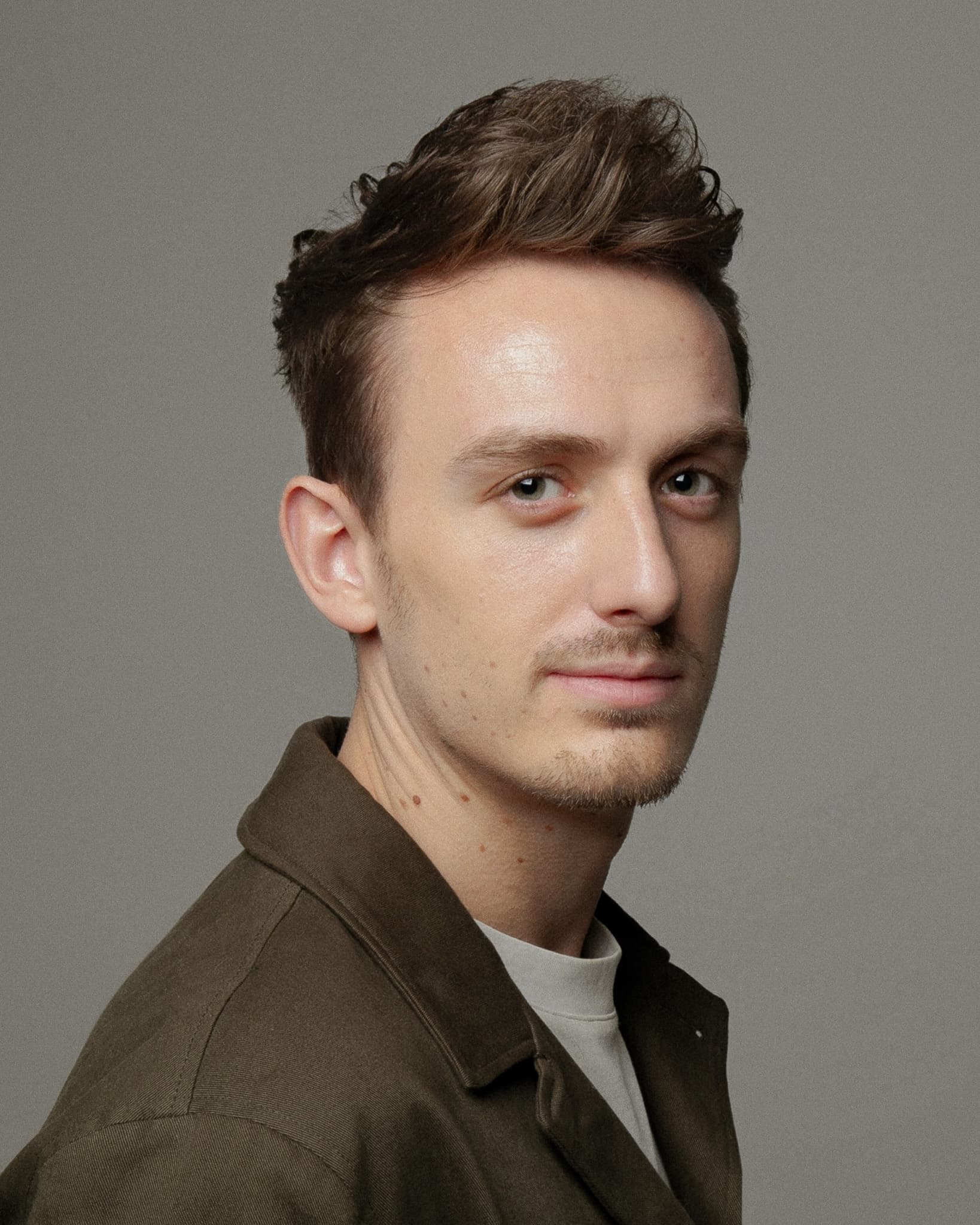 Ivo Adelaar in a colour studio portrait, turned three quarters to camera against a plain grey backdrop